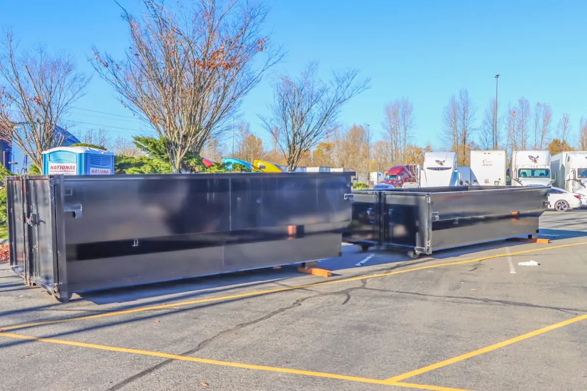Professional dumpster rental service with roll-off container on residential driveway in Claiborne